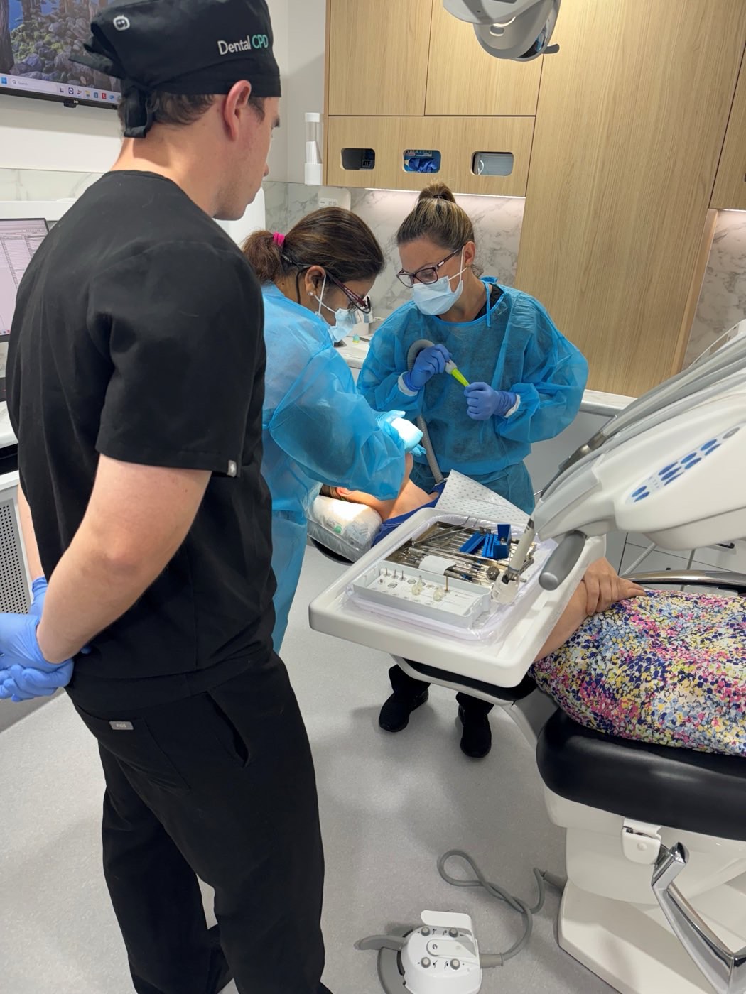 Clinicians treating a patient in the training surgery