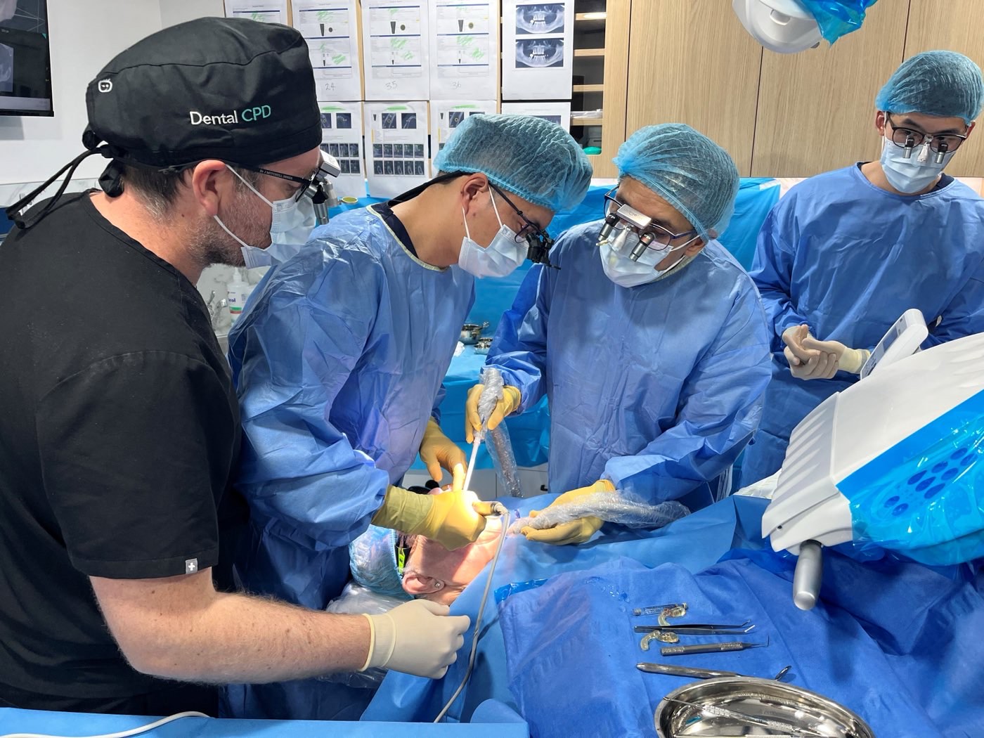 Course participants assisting during a live implant placement